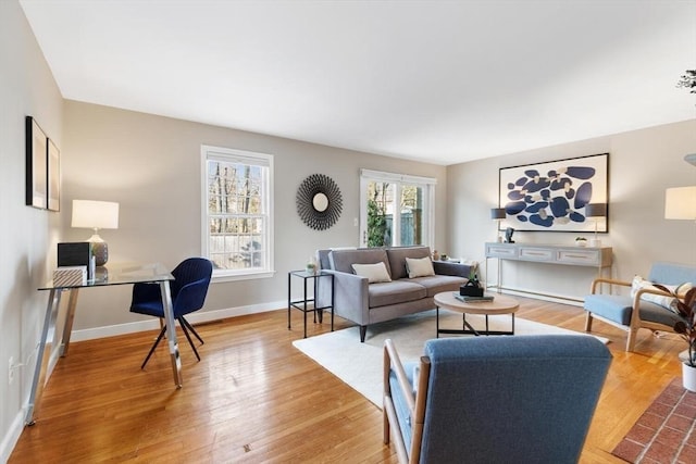 living area with light wood finished floors and baseboards