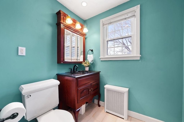 bathroom featuring baseboards, radiator, toilet, tile patterned floors, and vanity