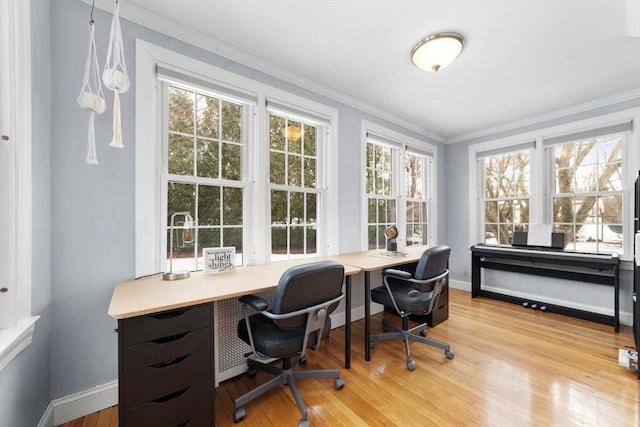 home office featuring baseboards, light wood-type flooring, and crown molding