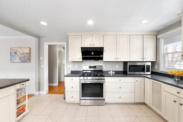 kitchen with light tile patterned floors, appliances with stainless steel finishes, dark countertops, and recessed lighting