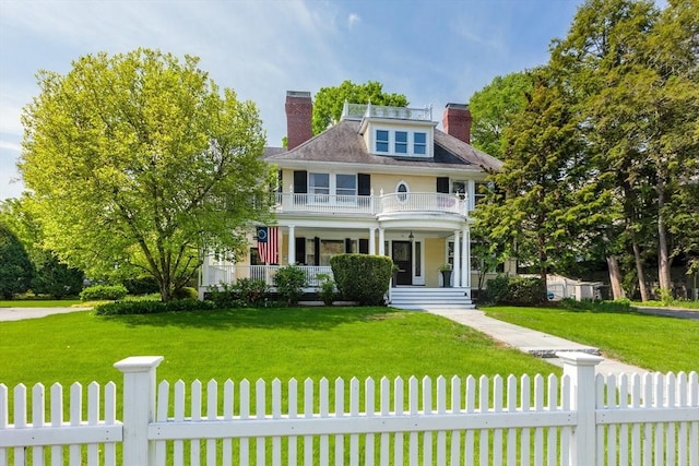 59 Elm St, Concord, MA 01742 - view of front of house featuring a balcony, a chimney, and covered porch
