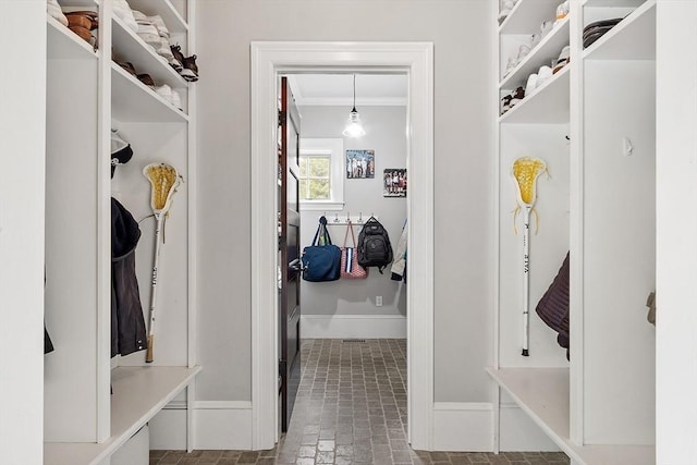 59 Elm St, Concord, MA 01742 - mudroom with crown molding, baseboards, and brick patterned flooring