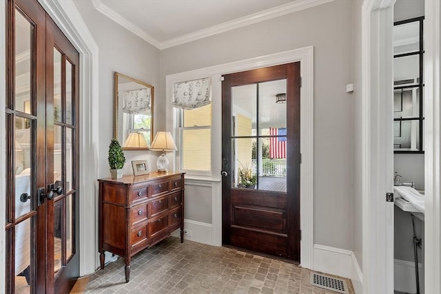 59 Elm St, Concord, MA 01742 - entrance foyer with french doors, brick patterned floors, crown molding, and baseboards