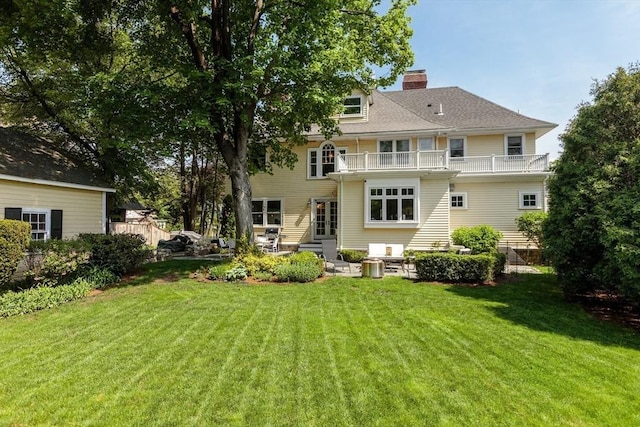 59 Elm St, Concord, MA 01742 - rear view of property featuring a balcony, a yard, a chimney, and a patio