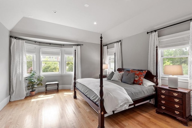 59 Elm St, Concord, MA 01742 - bedroom with multiple windows, light wood-style floors, baseboards, recessed lighting, and lofted ceiling