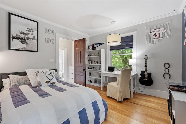 59 Elm St, Concord, MA 01742 - bedroom featuring ornamental molding, light wood-type flooring, baseboards, and a desk