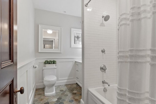 59 Elm St, Concord, MA 01742 - full bathroom featuring a decorative wall, wainscoting, shower / bath combo, toilet, and vanity