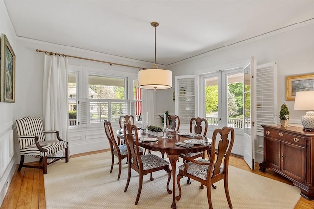 59 Elm St, Concord, MA 01742 - dining room featuring light wood finished floors and crown molding