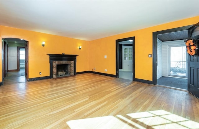 unfurnished living room featuring hardwood / wood-style flooring and a fireplace