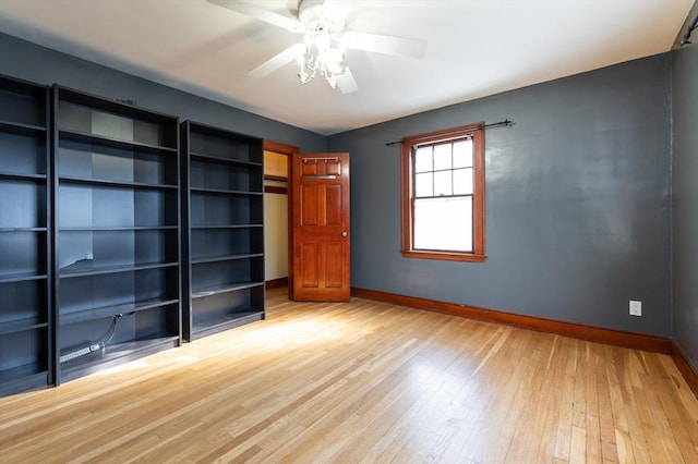 unfurnished bedroom with ceiling fan and light wood-type flooring