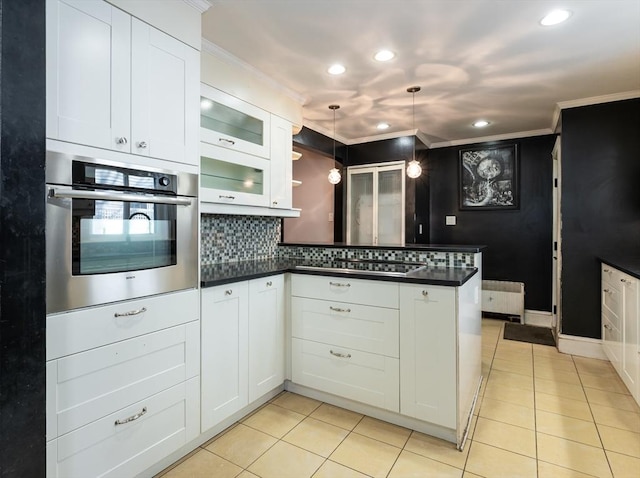 kitchen with gas stovetop, white cabinetry, crown molding, pendant lighting, and oven