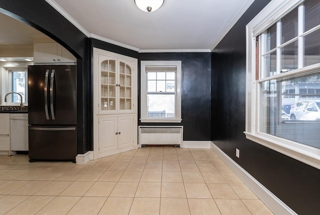 kitchen featuring sink, black fridge, radiator, dishwasher, and white cabinets