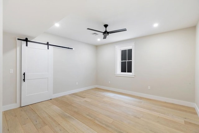 2 Candle House Ln, Nantucket, MA 02564 - spare room featuring light wood-style flooring, a ceiling fan, a barn door, and recessed lighting