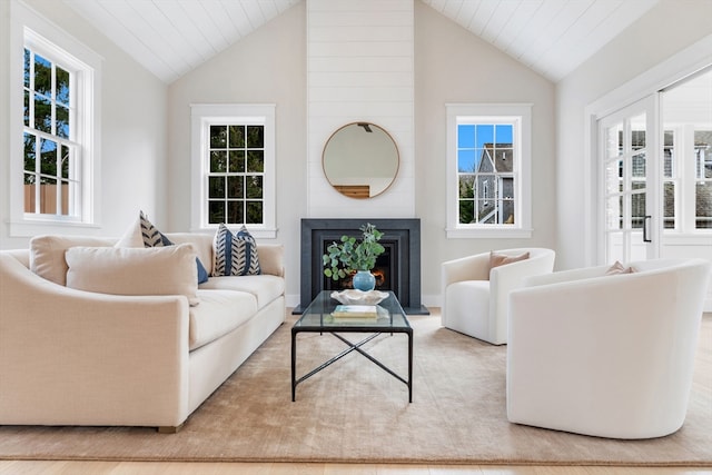 2 Candle House Ln, Nantucket, MA 02564 - living room with a warm lit fireplace, vaulted ceiling, and a healthy amount of sunlight