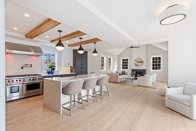 2 Candle House Ln, Nantucket, MA 02564 - kitchen with open floor plan, a kitchen bar, range with two ovens, and beam ceiling
