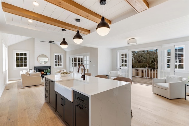 2 Candle House Ln, Nantucket, MA 02564 - kitchen with open floor plan, light wood-style flooring, a sink, and pendant lighting