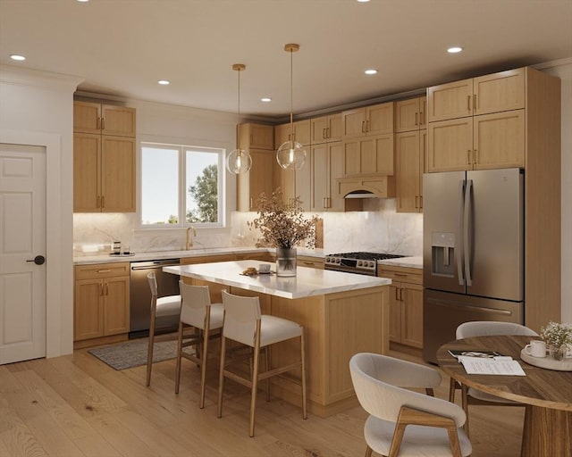 kitchen featuring decorative light fixtures, stainless steel appliances, light countertops, a kitchen island, and light wood-type flooring