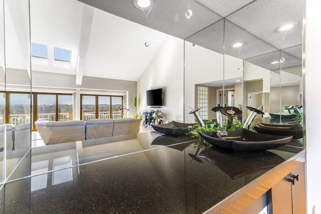 living room featuring recessed lighting and high vaulted ceiling