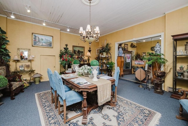 carpeted dining space featuring an inviting chandelier, rail lighting, and wood ceiling
