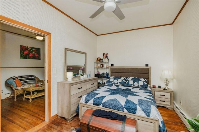 bedroom featuring wood finished floors, ornamental molding, baseboards, and a baseboard heating unit
