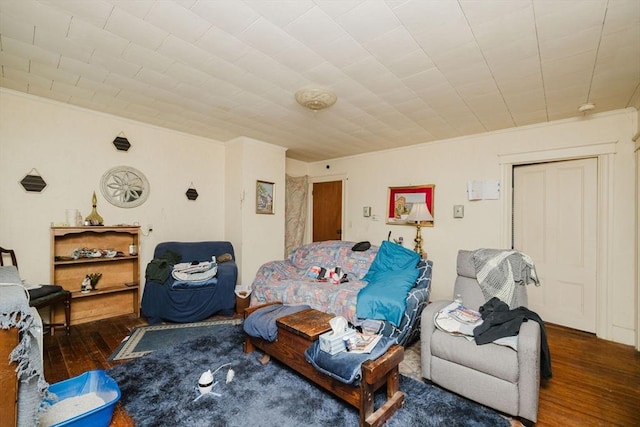 living area featuring crown molding and hardwood / wood-style floors