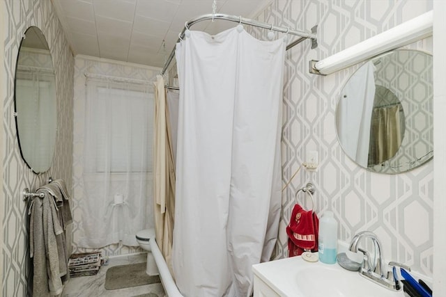 bathroom featuring a sink, toilet, ornamental molding, wallpapered walls, and a shower with shower curtain