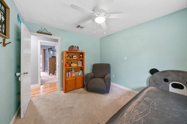 bedroom featuring light carpet and ceiling fan