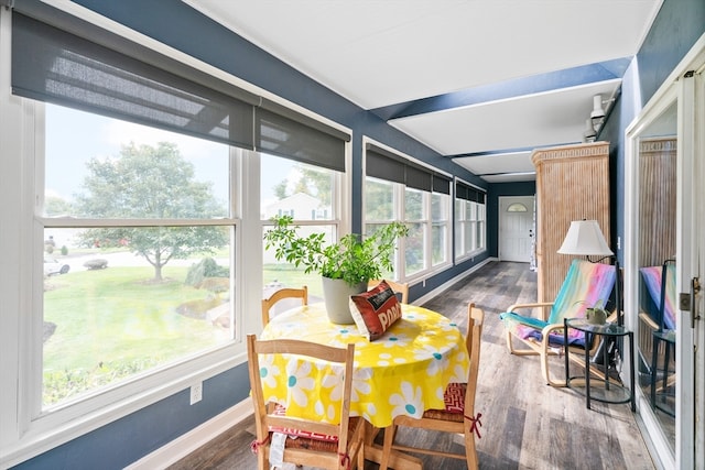 sunroom featuring lofted ceiling and plenty of natural light