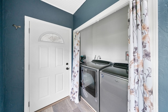 washroom with washer and dryer and light wood-type flooring