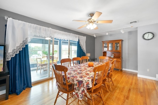 dining area featuring light hardwood / wood-style floors, rail lighting, and ceiling fan