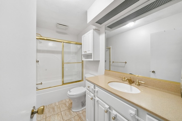 full bathroom with toilet, bath / shower combo with glass door, vanity, and tile patterned flooring