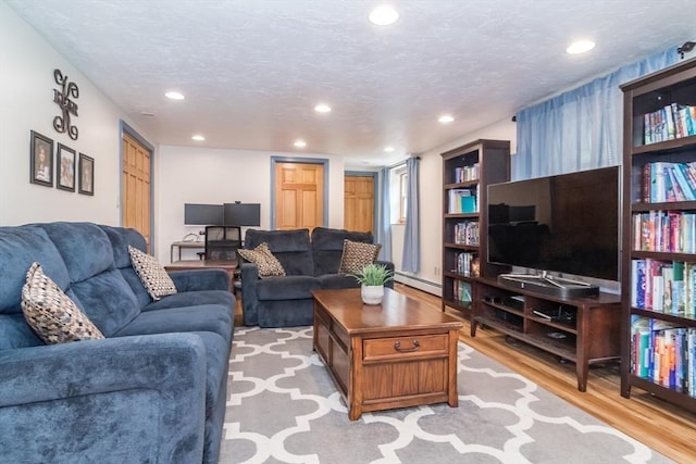 146 S Main St, Natick, MA 01760 - living area featuring a baseboard heating unit, light wood-style flooring, and recessed lighting