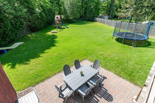 146 S Main St, Natick, MA 01760 - view of yard featuring a patio area, outdoor dining area, a trampoline, and a playground