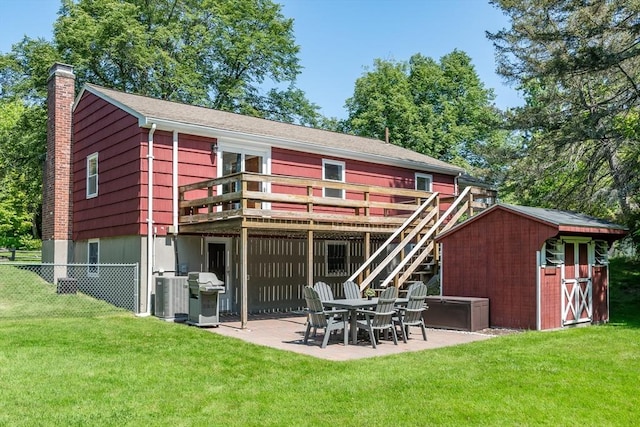 146 S Main St, Natick, MA 01760 - rear view of house featuring a chimney, a wooden deck, and a patio area
