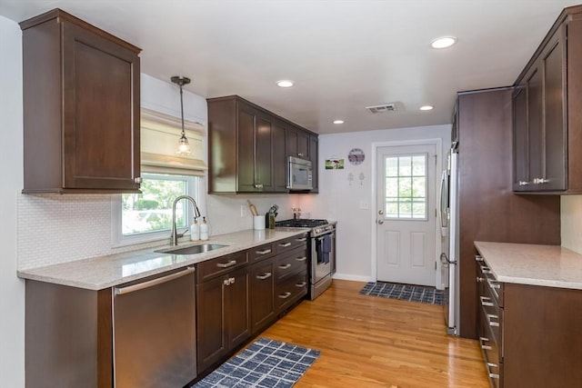 146 S Main St, Natick, MA 01760 - kitchen with appliances with stainless steel finishes, a sink, healthy amount of natural light, light wood-style flooring, and recessed lighting