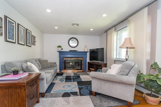 146 S Main St, Natick, MA 01760 - living room featuring recessed lighting, wood finished floors, a fireplace, and baseboard heating