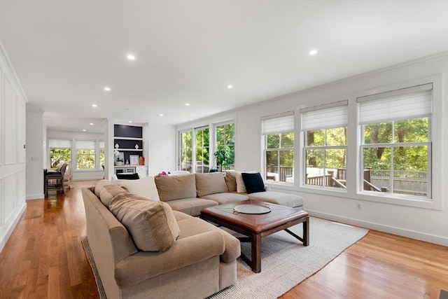 living area featuring plenty of natural light, recessed lighting, and light wood-type flooring