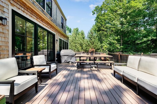 wooden deck featuring area for grilling, outdoor dining space, and outdoor lounge area