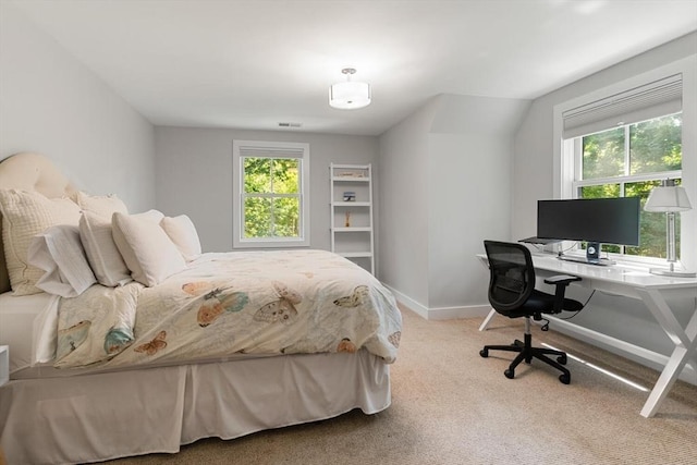 carpeted bedroom featuring visible vents and baseboards