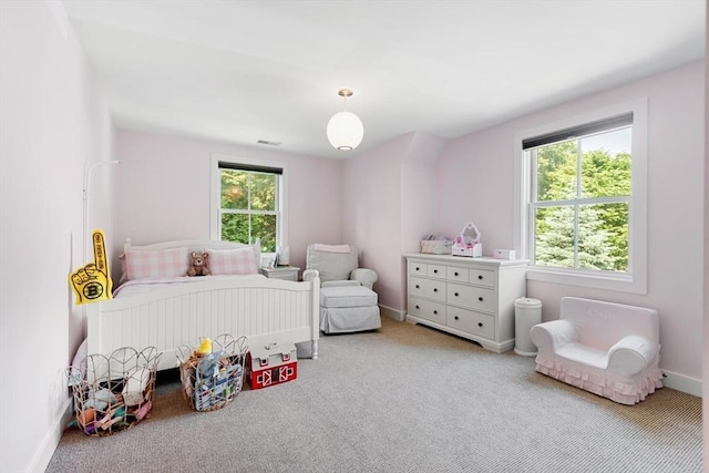 bedroom featuring visible vents, light colored carpet, and baseboards