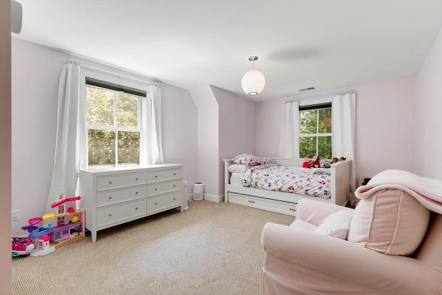 carpeted bedroom featuring visible vents