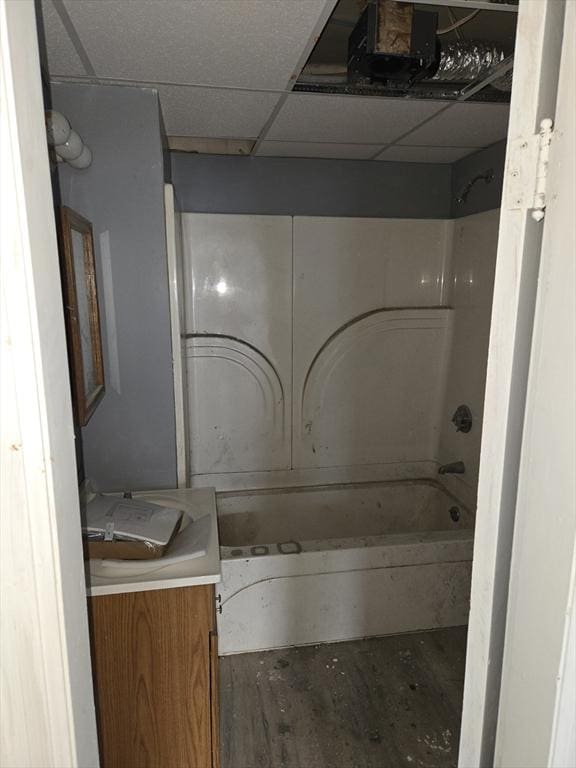 full bath featuring tub / shower combination, vanity, and a paneled ceiling