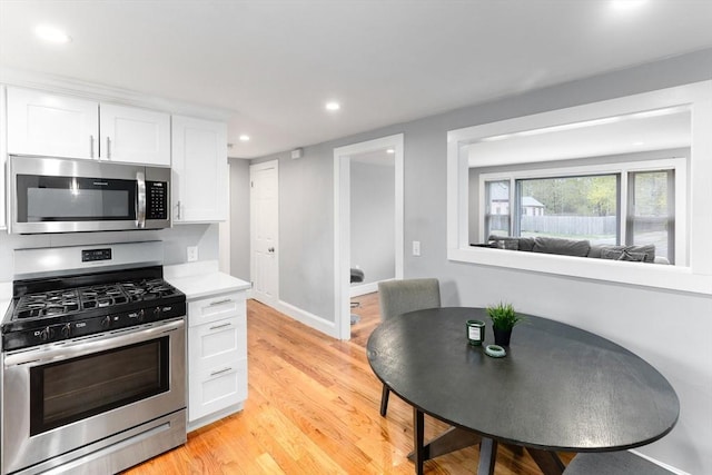 kitchen featuring light wood-style flooring, white cabinetry, recessed lighting, appliances with stainless steel finishes, and light countertops