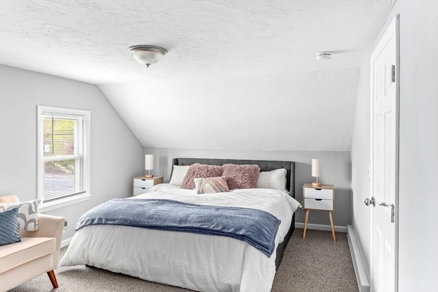 bedroom featuring carpet flooring, a textured ceiling, lofted ceiling, and baseboards