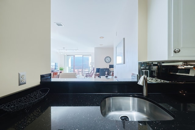 kitchen featuring sink and white cabinets