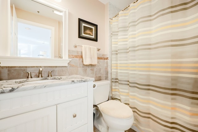 bathroom featuring tile walls, vanity, a shower with curtain, and toilet