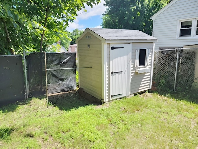 view of outbuilding featuring a lawn