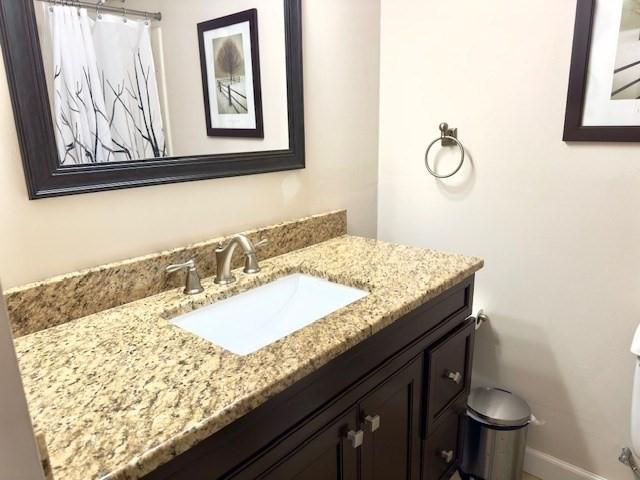 bathroom featuring vanity and toilet