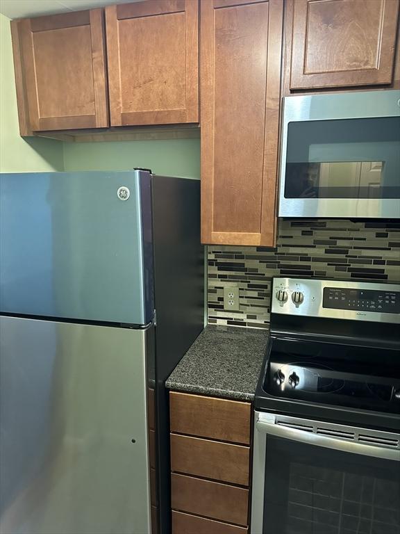 kitchen with stainless steel appliances and tasteful backsplash