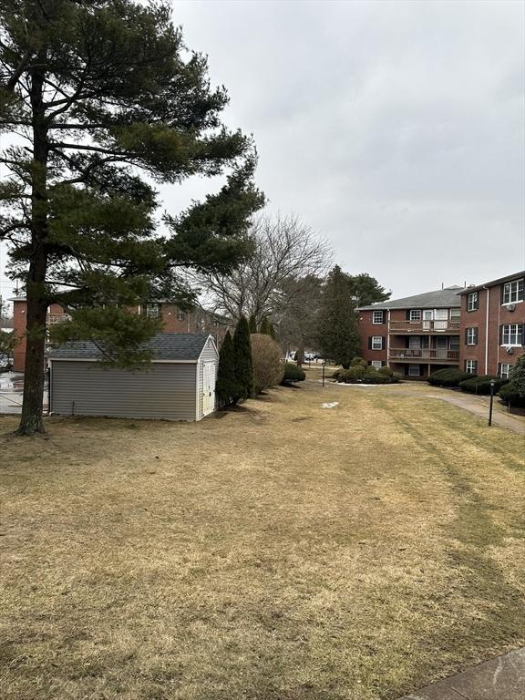 view of yard featuring an outdoor structure and a storage unit